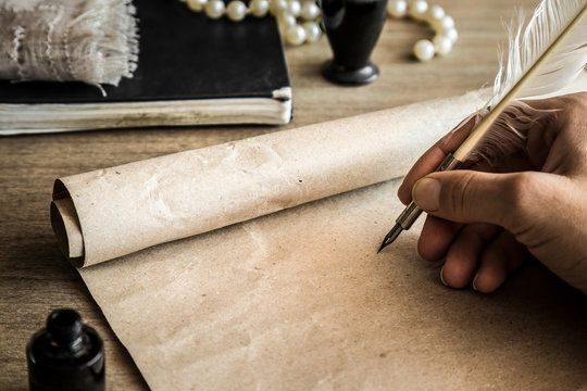Hand writing with old quill pen on the old paper. Historical atmosphere. Empty place for a text.