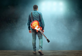 Artist Guitarist hands play on electricity guitar under light, P