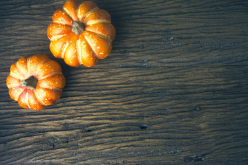 two halloween pumpkin on wood background