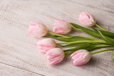 Fototapeta Tulipany - Bunch of Pastel Tulips on Wood Floor