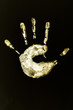 isolated image of a child's palm yellow on a black background