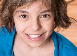 Emotional portrait of attractive caucasian little student girl with beautiful brown eyes. Funny cute smiling child looking at camera - close-up.