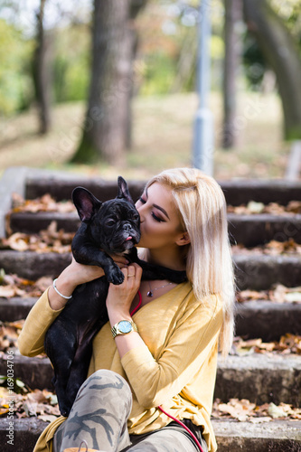 Beautiful And Happy Young Blond Woman Enjoying In Autumn Park With