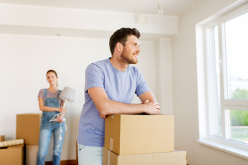 happy couple with boxes moving to new home