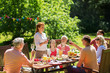 © Syda Productions - happy family having dinner or summer garden party