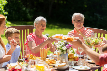 Wall Mural - happy family having dinner or summer garden party