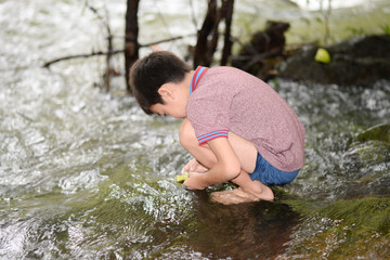 Poster - Littl boy playing at waterfall with happy and smile outdoor activeites with family