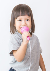 Wall Mural - Asian pretty little girl singing with microphone in her hand