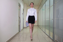 Businesswoman Walk Down The Hall In The Business Center.