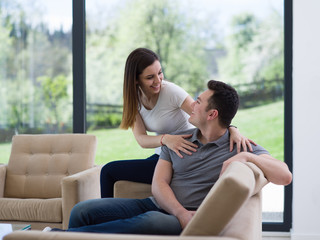 Wall Mural - young handsome couple hugging on the sofa