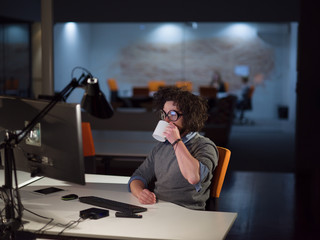 Wall Mural - man working on computer in dark startup office