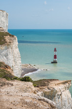 Red And White Beachy Head Lighthouse In Blue Sea English Channel Under Seven Sisters White Cliffs