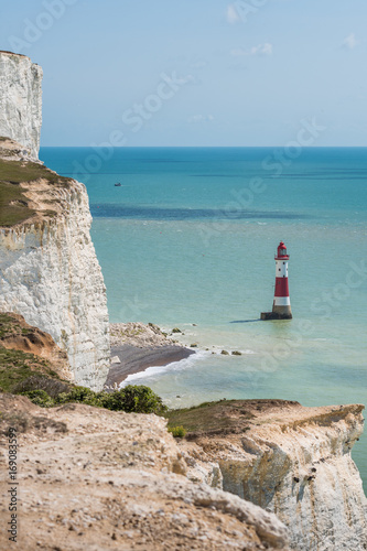 Fotografie, Obraz Red and white Beachy Head lighthouse in blue sea English Channel under Seven Sis