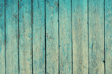 Fragment Of An Old Fence. Cracked Cyan Paint Texture. Shabby Aquamarine Paint Wooden Planks Background.