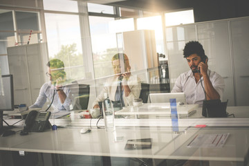 Wall Mural - People in operations center  talking on Landline phone. Operators in the office.