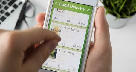 Ordering pizza using food delivery app on the smartphone