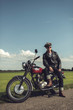 © ysbrandcosijn - Vintage motorcyclist having a break along rural road in summer.