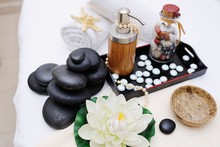 Stones For Massage , Massage Oil And A Flower In Spa Salon