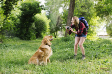 Woman Photographing Dog On Hiking Trip