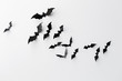 black paper bats over white background
