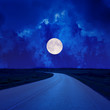 canvas print picture - full moon in clouds over asphalt road