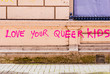 Pink graffiti on a wall saying 