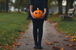 © Cindy Prins/Stocksy - Girl in a black tutu and tights holding a carved pupkin