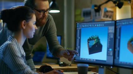 Poster - Female Game Developer Has Discussion with Male Project Manager While Working on a Game Level on Her Personal Computer with Two Displays. They Work in a Modern Loft Office Creative Environment. 