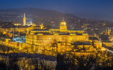 Wall Mural - Budapest, Hungary - The Historic Royal Palace aka Buda Castle with Matthias Church and the Buda Hills at background at blue hour