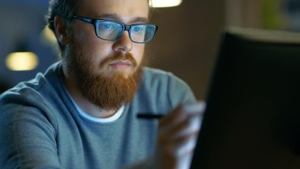 Poster - Talented Young Concept Artist Drawing on a Digital Pen Display Tablet While Sitting at His Working Place in Modern Loft Office. Late at Night. Shot on RED EPIC-W 8K Helium Cinema Camera.