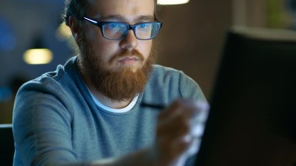 Poster - Talented Young Concept Artist Drawing on a Digital Pen Display Tablet While Sitting at His Working Place in Modern Loft Office. Late at Night. Shot on RED EPIC-W 8K Helium Cinema Camera.