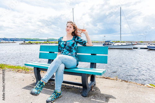 Young woman sitting on blue bench overlooking peaceful Saint Lawrence river  in Portneuf, Quebec, Canada - Buy this stock photo and explore similar  images at Adobe Stock | Adobe Stock