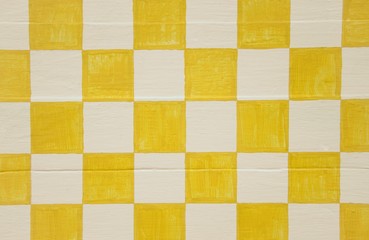 Yellow and white checkerboard design on wood panel background