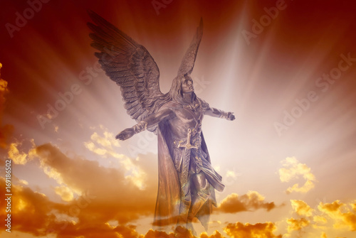 Fotografía Angel archangel Michael over divine sky with rays of light