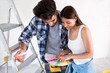 © didesign - Young couple choosing colors for painting their home