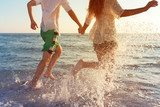 Fototapeta  - Happy young couple enjoying the sea
