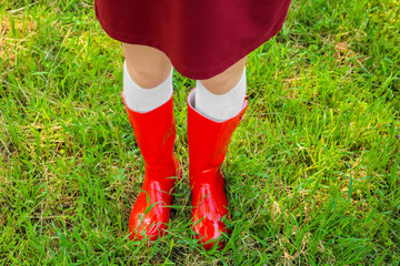 Young woman in red wellington boots outdoors