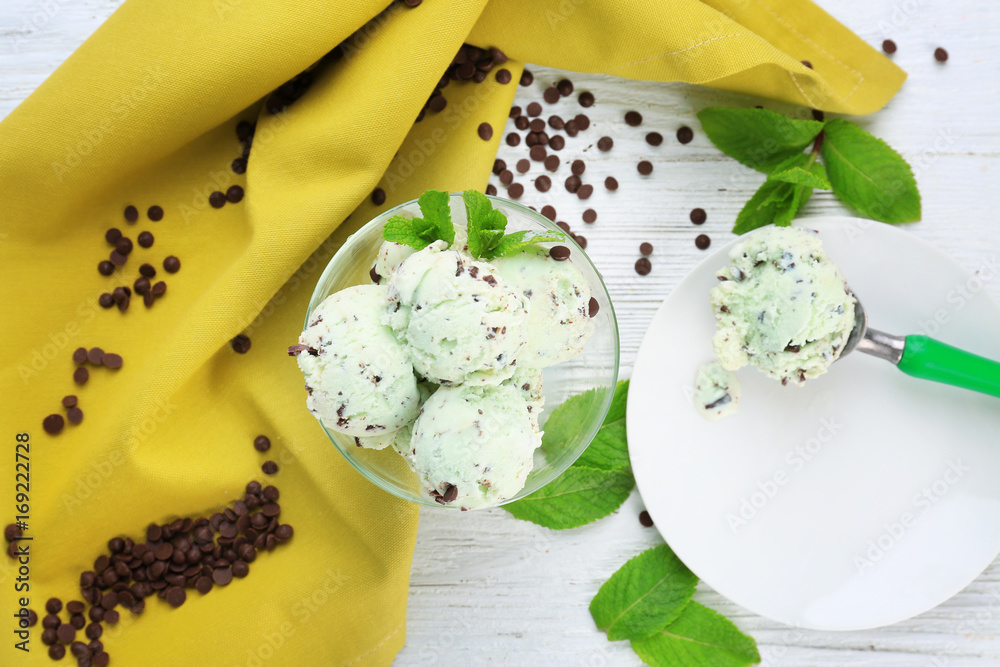 Composition with mint chocolate chip ice cream on white wooden table