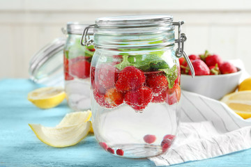 Wall Mural - Jar with delicious strawberry lemonade on table