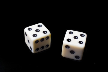 Dice on a black background - selective focus