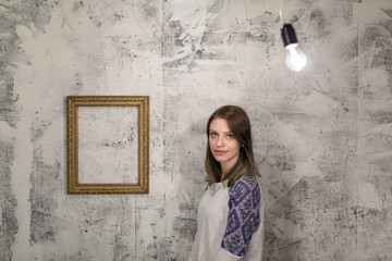 Wall Mural - young girl posing in studio between lighbulbs