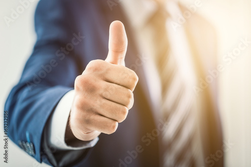 Fotografía Business man shows thumb up sign gesture.