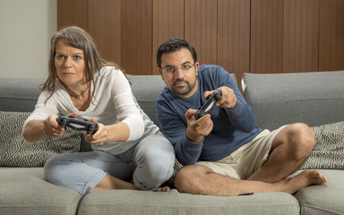 Wall Mural - couple playing video games in their city apartment