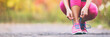 Leinwandbild Motiv Running shoes runner woman tying laces for autumn run in forest park panoramic banner copy space. Jogging girl exercise motivation heatlh and fitness.