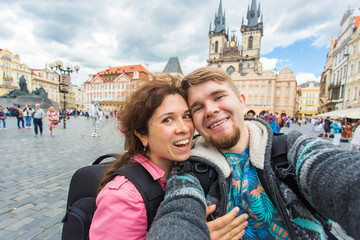 Wall Mural - tourists couple taking selfie on city street. Vacation, love, travel and holiday concept.