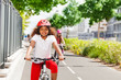 © Sergey Novikov - Happy African girl riding bicycle on cycle path