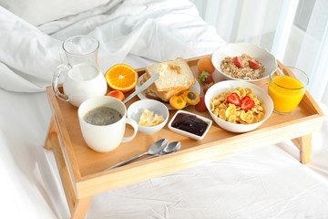 Canvas Print - Delicious sweet breakfast with coffee on bed