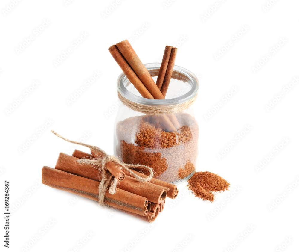 Composition with sweet cinnamon sugar on white background
