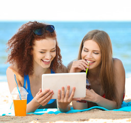 Wall Mural - Beautiful young women resting on beach at sea resort