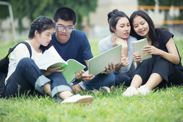 Asian Group of students sharing with the ideas for working on garden the campus lawn